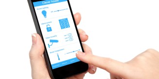 woman hand holding the phone with system clever house